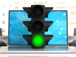 Green light. Traffic light, green go signal, on a computer, office background. 3d illustration